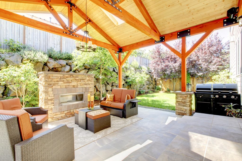 Wildfire Design Build-Rear yard covered outdoor patio, vaulted post and beam Ceiling, freestanding fireplace, BBQ.